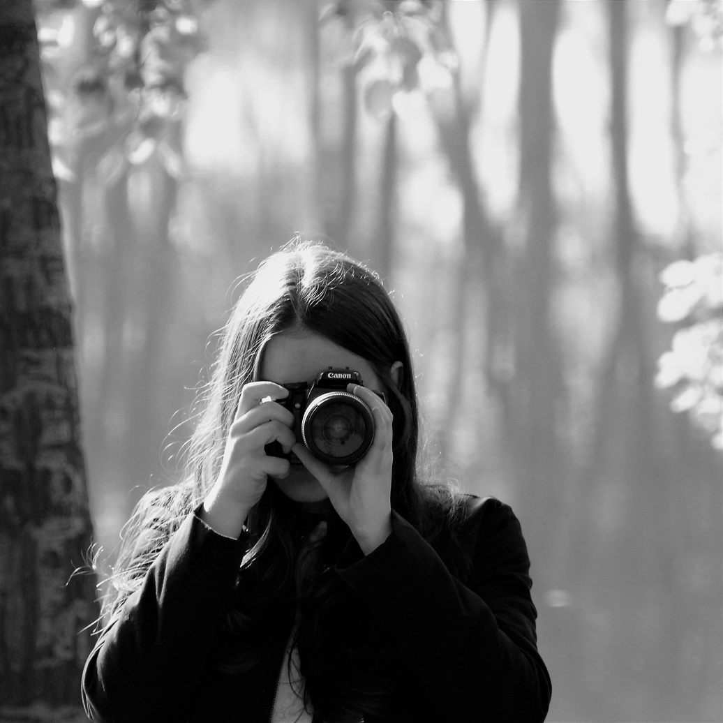 Grayscale Photography of Woman Holding Camera